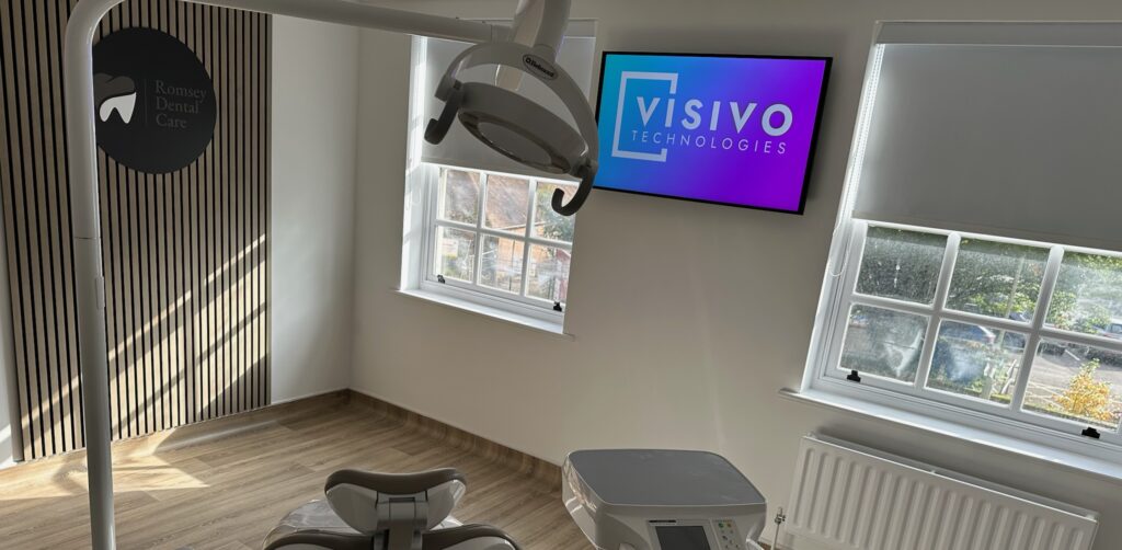 Dental chair with digital display in background